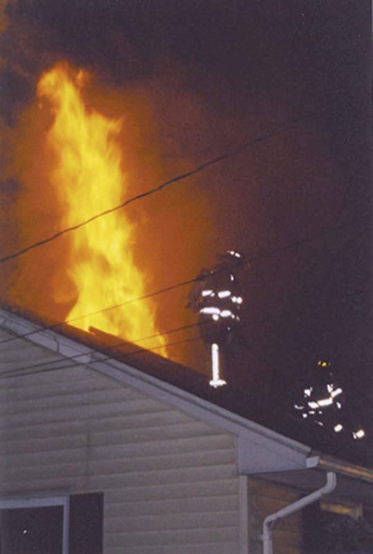 Cheshire Fire Fighters ventilate the roof during a fire at this residence on Westland Road.